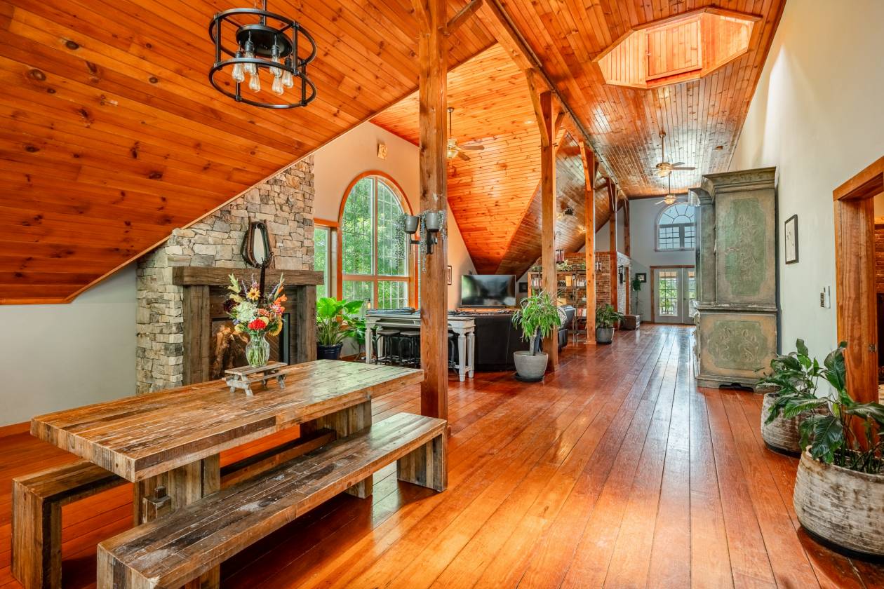 Open concept living room with wood beams